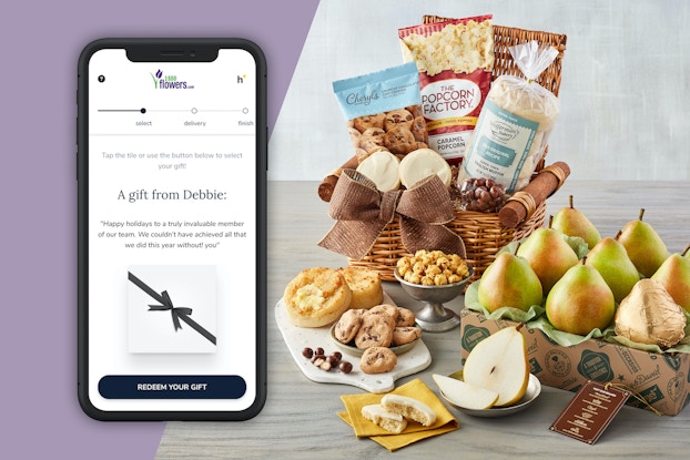 Phone screen showing a 1-800-Flowers order next to a display of the company's food.