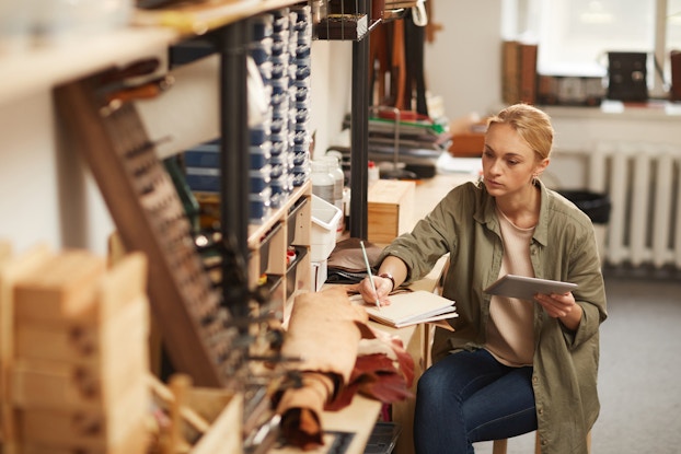 woman working on tablet in workshop