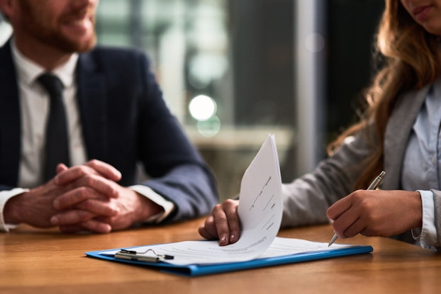 woman signing a contract