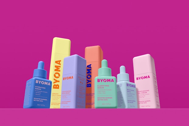  Product display of BYOMA skin care bottles in front of a fuschia background.