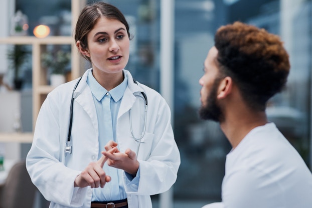  female doctor talking to a male patient