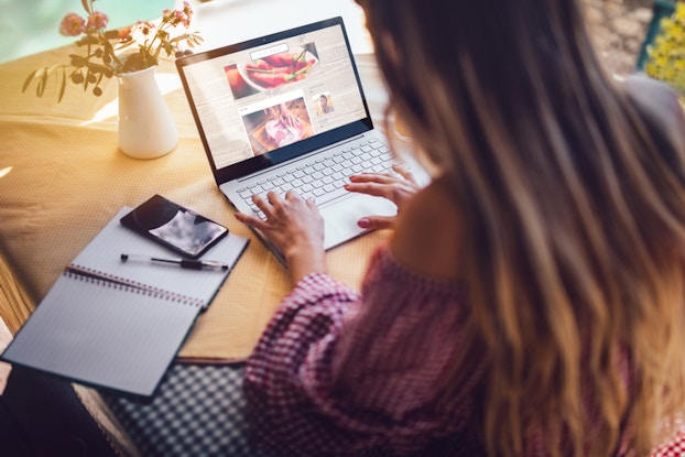  girl sitting at desk on laptop