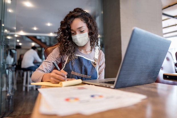  woman doing business with mask on