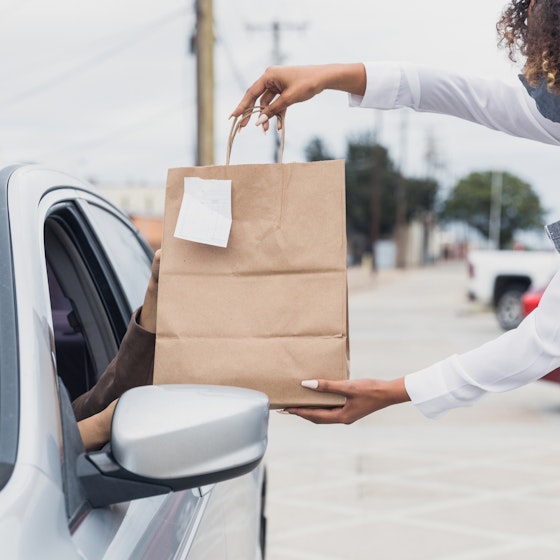 A customer picks up a purchase using curbside pickup.