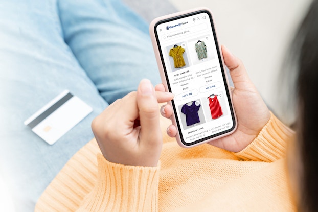 Person shopping on GoodwillFinds.com on their phone.