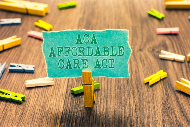 affordable care act sign with wooden clips