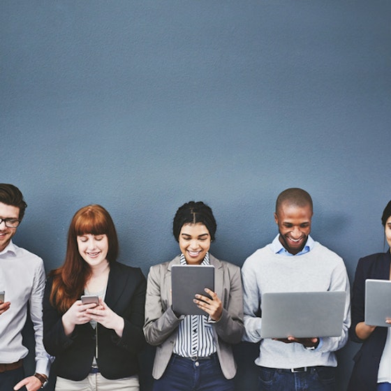 group of people standing in a line on mobile devices