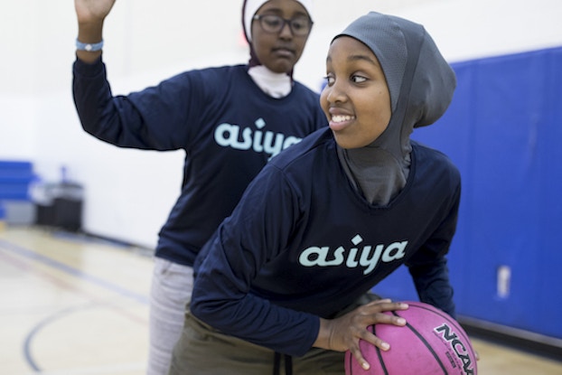  two girls playing basketball in asiya sports hijabs