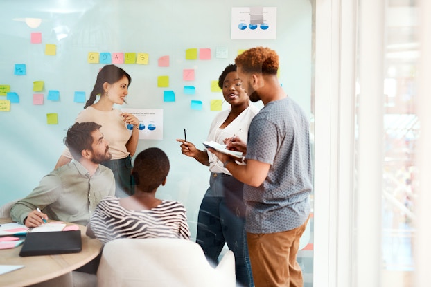 Group of young businesspeople collaborate in an office meeting