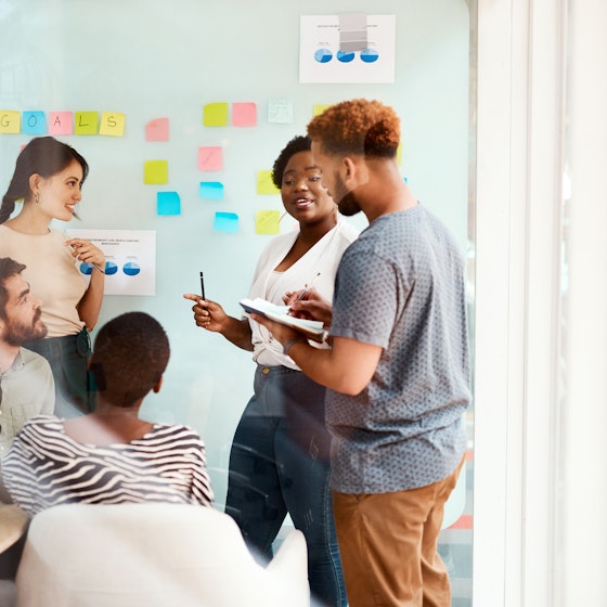 Group of young businesspeople collaborate in an office meeting