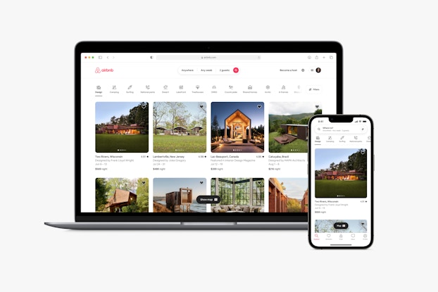Image of a laptop screen and a phone screen showing an Airbnb search results page.