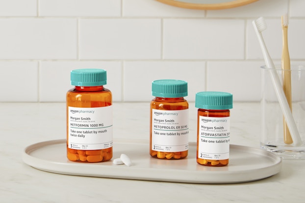  Display of prescription bottles and pills filled by Amazon Pharmacy.