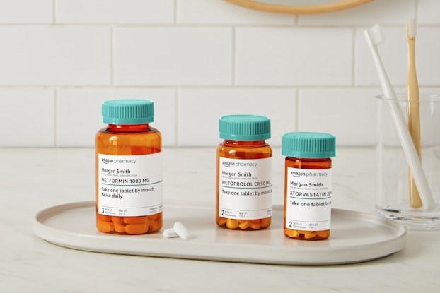 Display of prescription bottles and pills filled by Amazon Pharmacy.