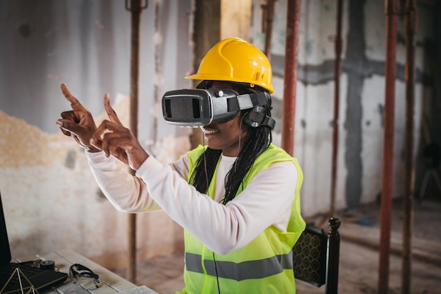  Woman uses augmented reality virtual or reality technology on worksite