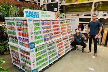  Co-founders of Back to the Roots standing with a product display inside a store. 