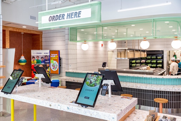  Interior of a Chopt location displaying the digital ordering pads.