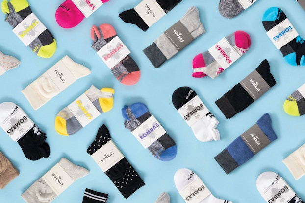  Bombas socks all spread out on a light blue background.