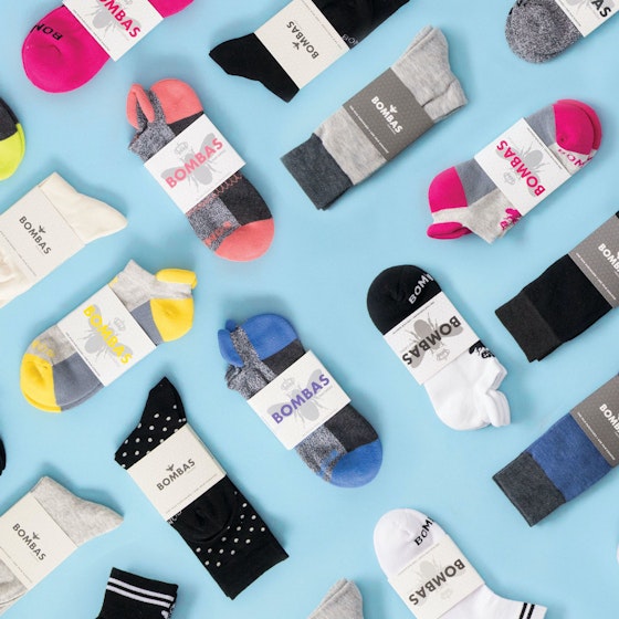 Bombas socks all spread out on a light blue background.