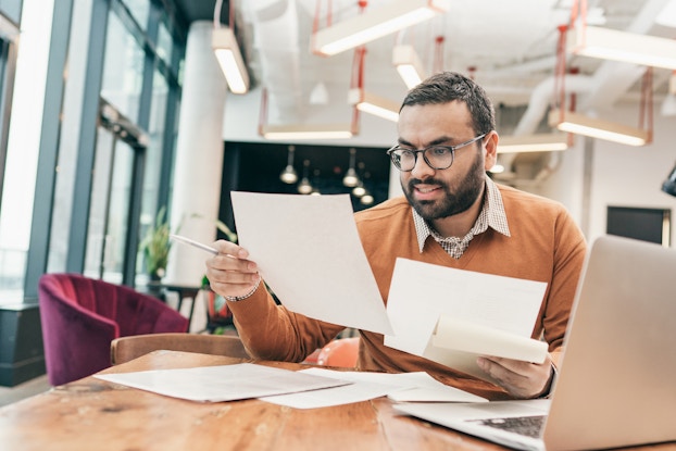 Businessman reviews financial documents
