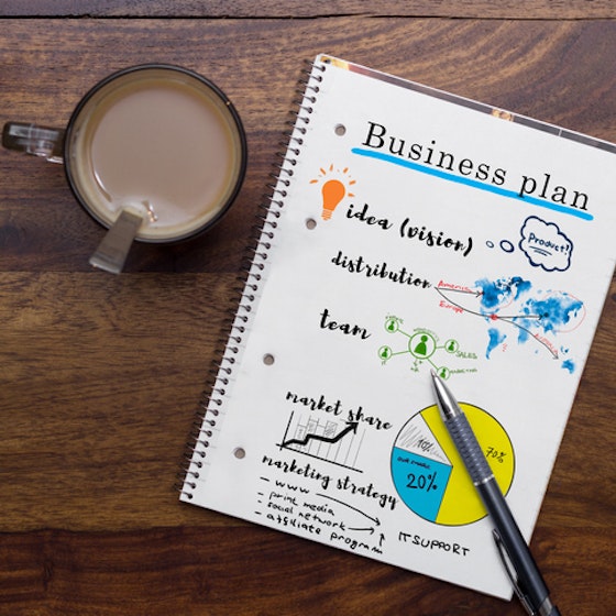 Business plan in notebook on a table