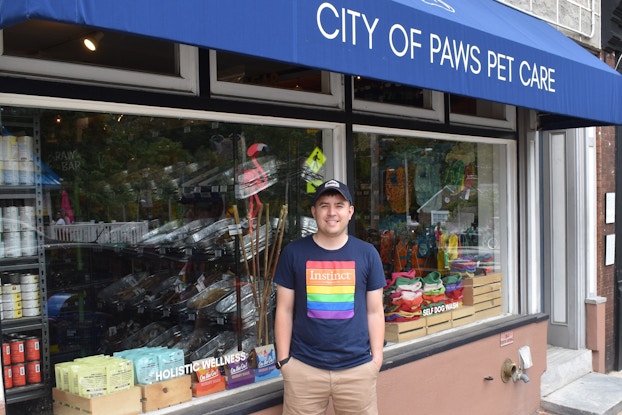  Danny Offenbacher, owner of City of Paws Pet Care, in front of his storefront.