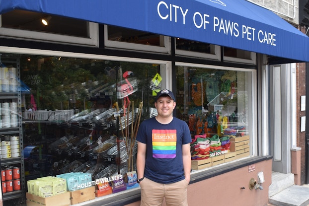 Danny Offenbacher, owner of City of Paws Pet Care, in front of his storefront.