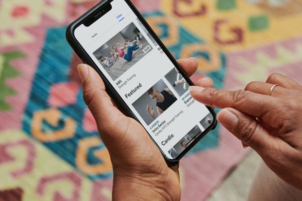  person holding phone browsing classpass workouts