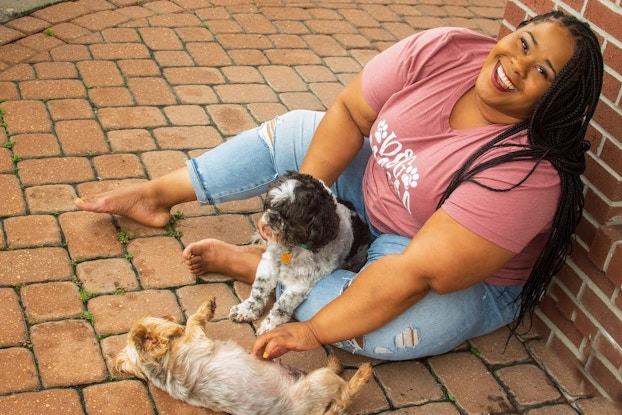 Courtney McWilliams, owner of MaryMac’s Doggie Retreat, posing with dogs.