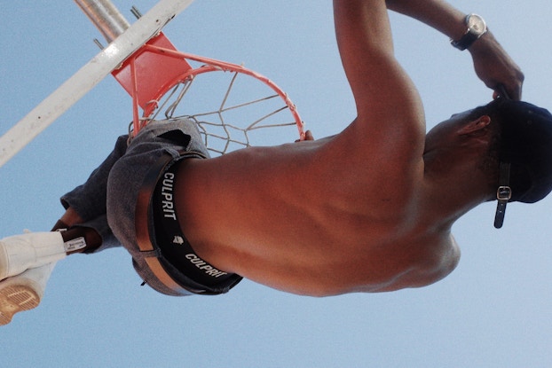  An upside-down shot of a model playing basketball wearing Culprit Underwear.
