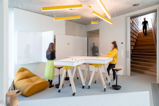  Interior of Alcon Lighting, with a desk and employees.