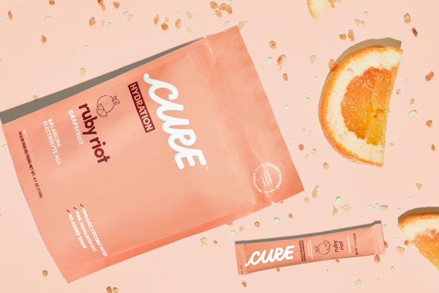 cure hydration packaging on a table with an orange slice