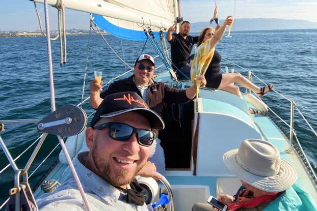 People having fun on a boating experience offered by Blueboard.