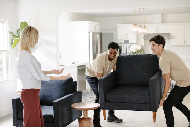  two men moving fernish furniture