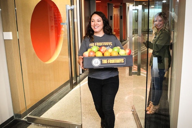 Erin Mittelstaedt, CEO of The FruitGuys delivers a box of fresh fruit.