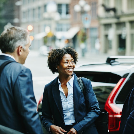 Woman talking to business colleagues outside