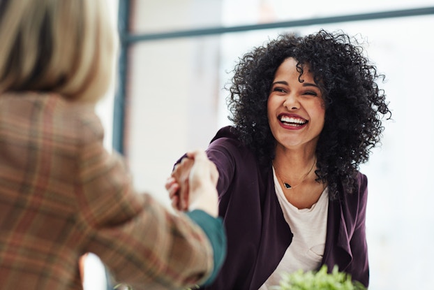 Business women shake hands
