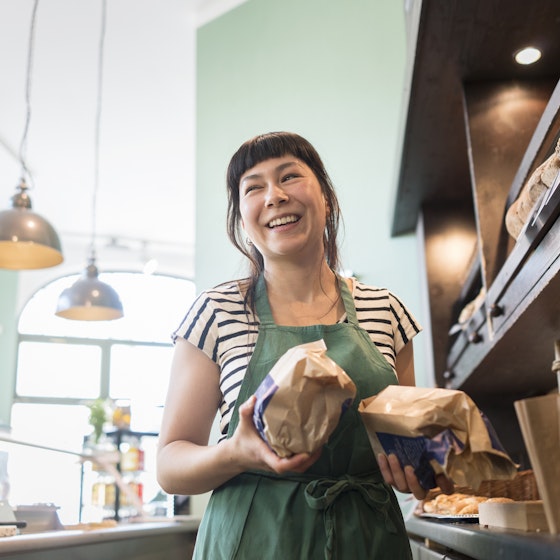Smiling small business owner inside a bakery.