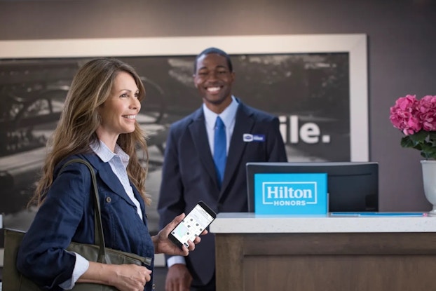  People checking into a Hilton hotel.