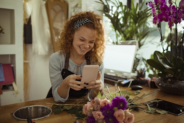  Flower shop owner uses phone to promote business