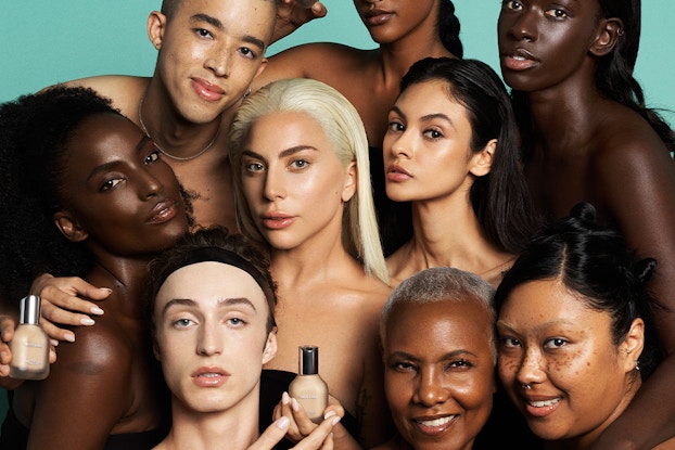  Lady Gaga surrounded by a group of diverse models wearing makeup by Haus Labs.