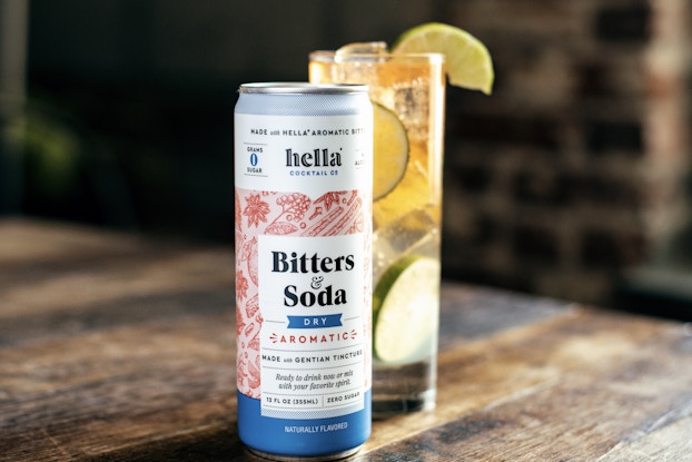  a bitters & soda can with a drink on display by Hella Cocktail Co.
