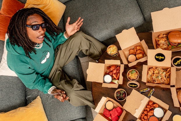  Wiz Khalifa posing with takeout boxes of food from HotBox by Wiz Khalifa.