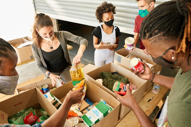 Group of volunteers packing boxes of items for donation
