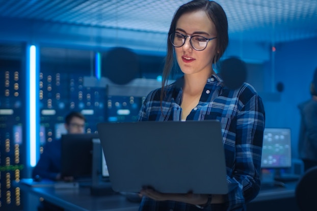 Woman works on laptop in technical department