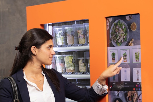  Customer purchasing food from Icebox Café's vending machine.
