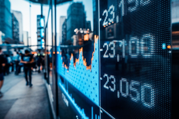 Image of stocks on digital board on the street