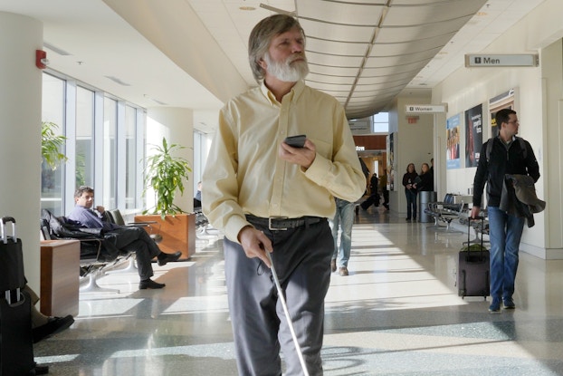  man with cane using indoor explorer app