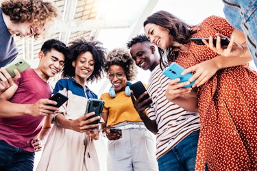  Diverse group of teenager looking and content on a smartphone 