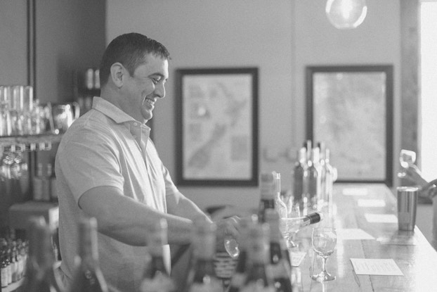 Campbell Davis, owner of LouElla Wine Beer & Beverages, working behind the bar.