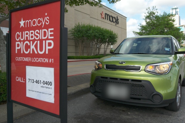  macy's curbside pickup sign with car parked